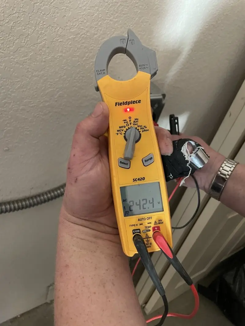 Voltage testing with clamp meter during Recessed Lighting Installation in Wheatfield
